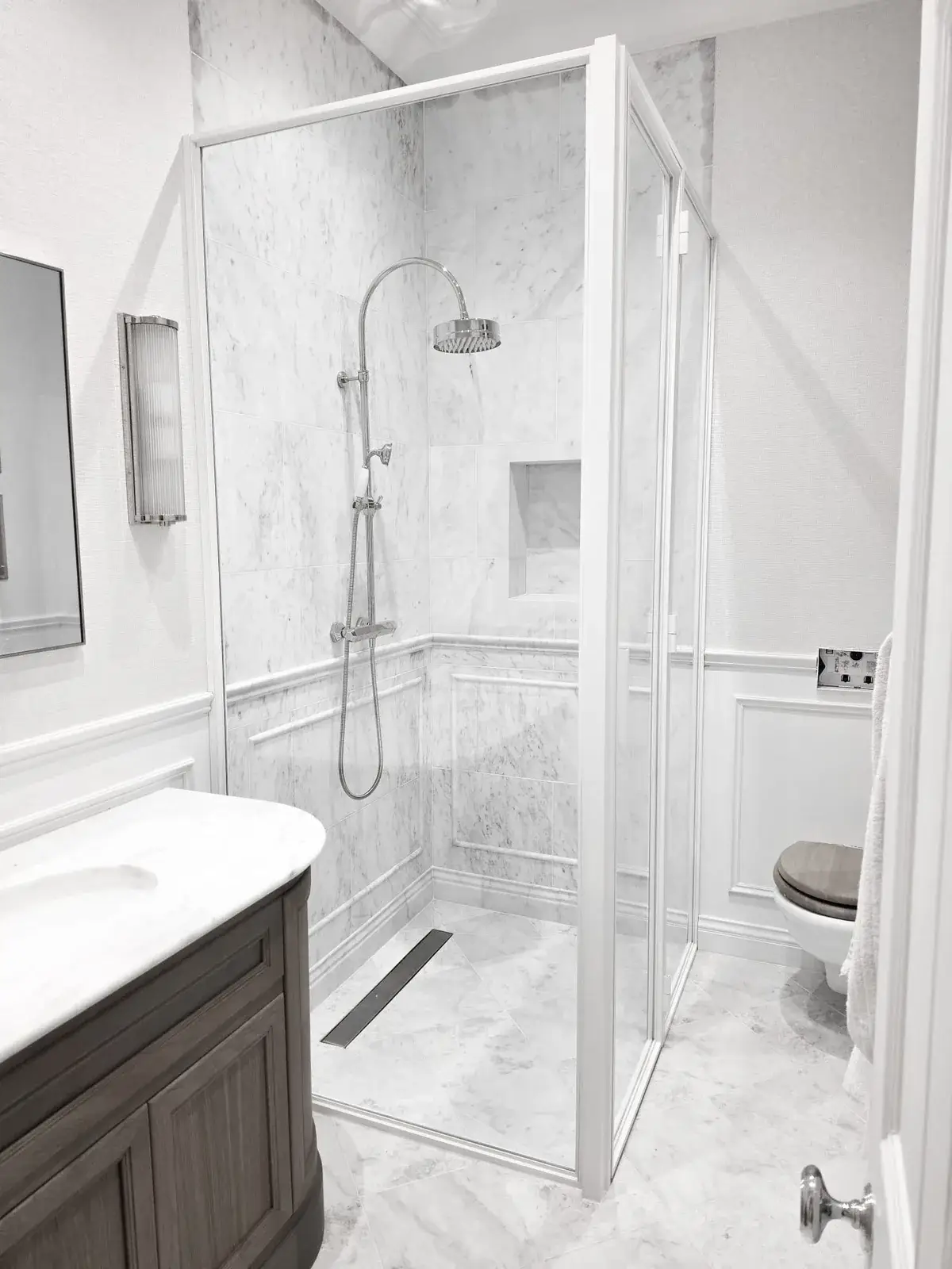 KP Glazing London Bathroom with a dark wood vanity, a glass-enclosed marble shower, and a loo.